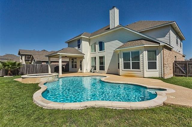 Your family's private oasis! In ground pool (heated), hot tub, covered patio & pool surround.