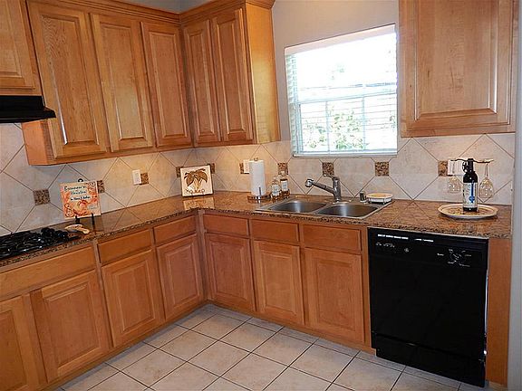 The spacious kitchen has granite countertops.