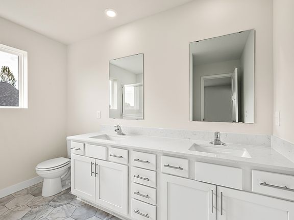 The master bedroom is spacious with a large window.
