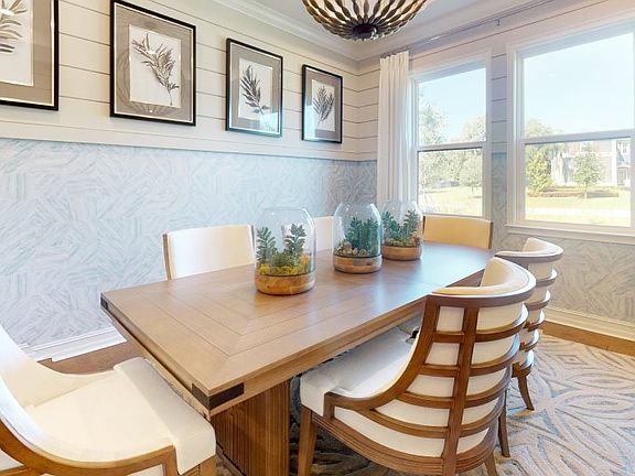 The formal dining room enjoys an elegant design with increased privacy for celebrations or gathering
