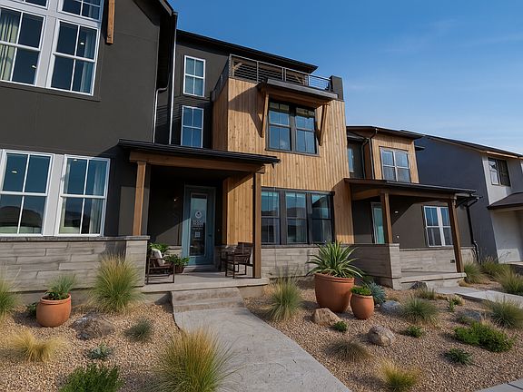 A modern two-story house with large windows, wood and dark exterior finishes, a small front porch wi