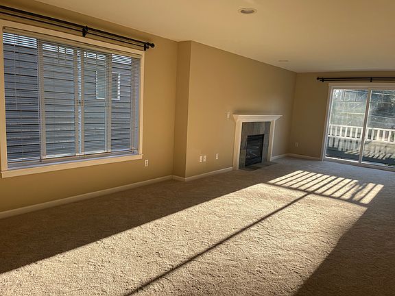 living space with fireplace and balcony