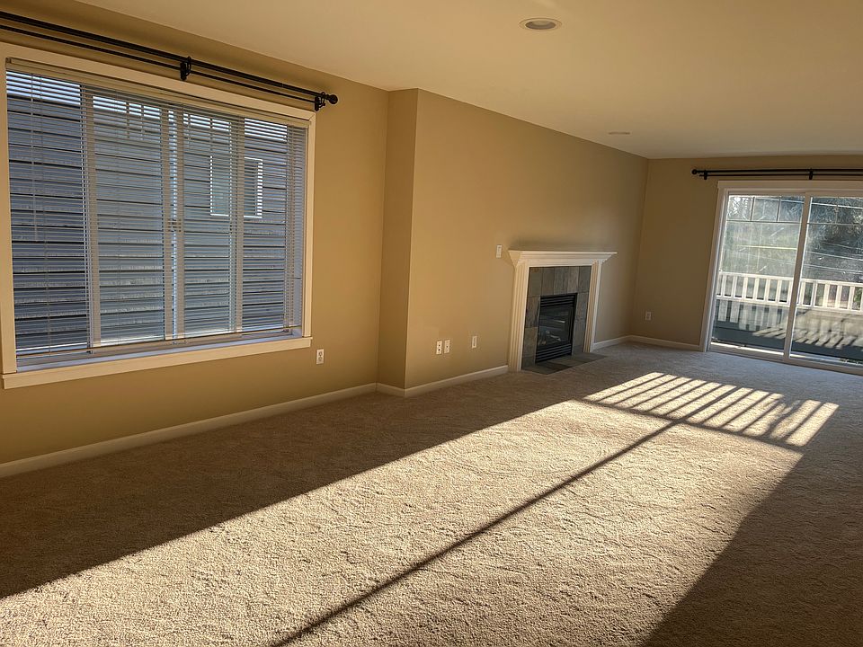 living space with fireplace and balcony