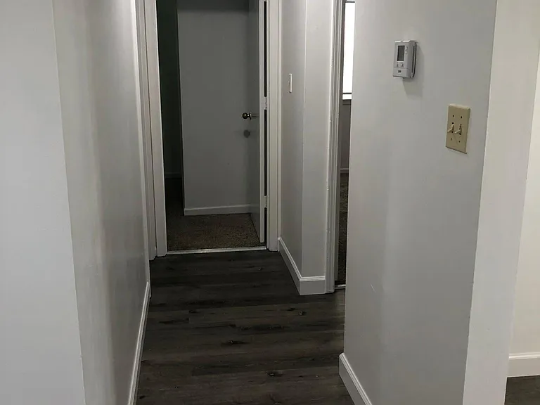 Hall to first bedroom and bathroom off of the kitchen