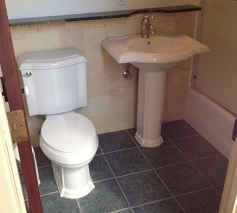 Bathroom has tub/shower, stone tile and green marble