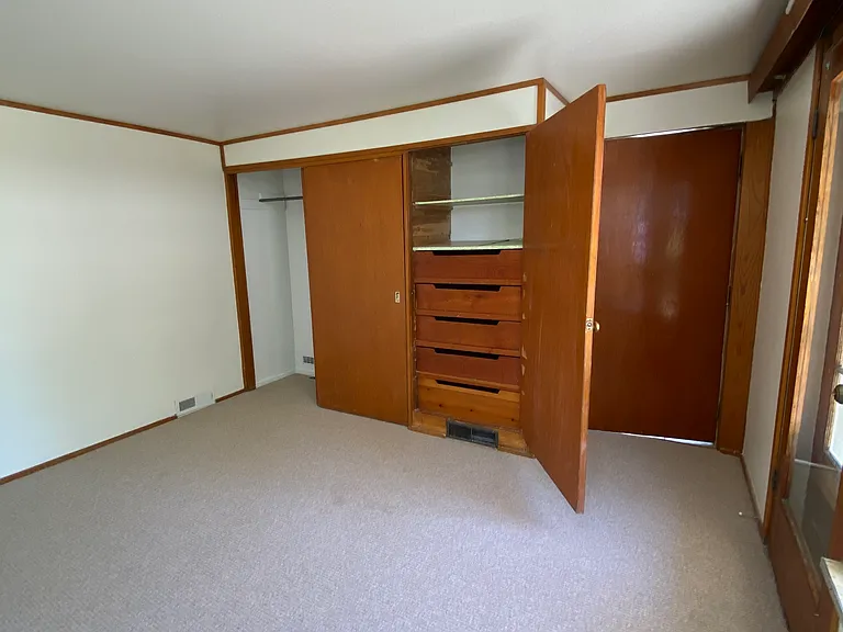 Bedroom 1: New wool carpet, closet and built cabinets.