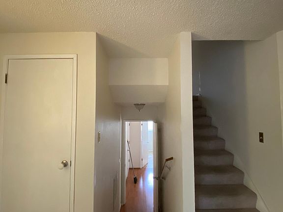 Left side of entrance leads down stairs to living room or upstairs to bedrooms