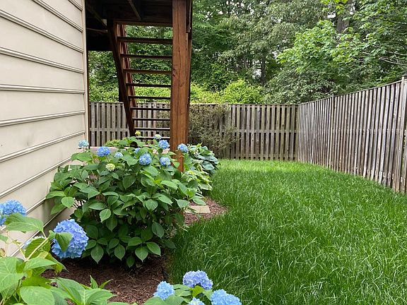 Inside fenced lawn, with two-tier deck. Backyard faces lots of trees and feels secluded.