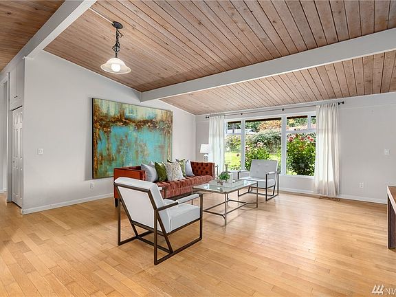 Living room with a picturesque wall of windows providing an abundance of natural light.