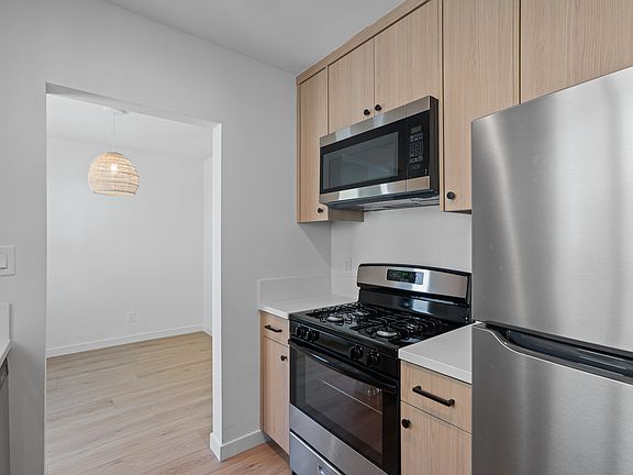 Kitchen with microwave and range and fridge
