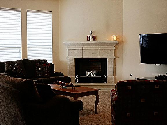 Open living room with gas fireplace, 2 in blinds. Plenty of space.