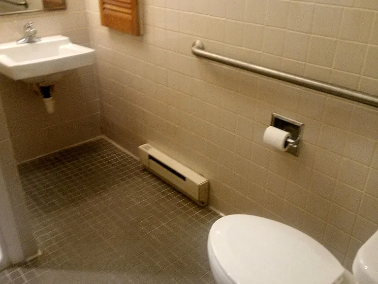 Space between toilet and sink. Wheel chair accessible.