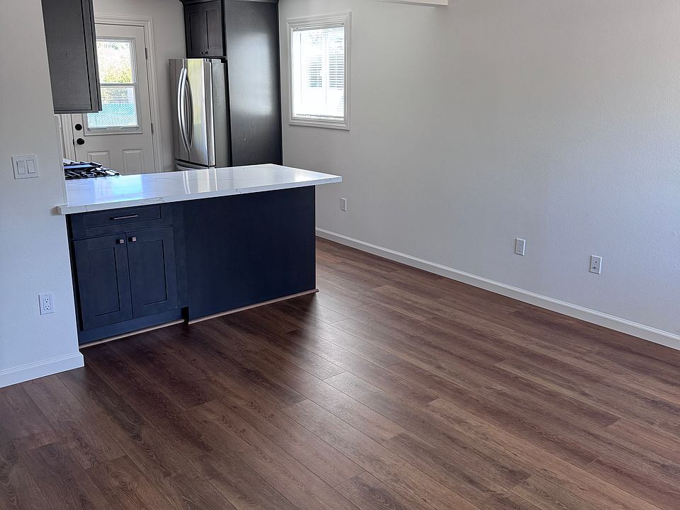 view of living room and kitchen from front door
