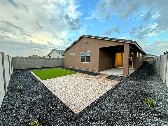 Backyard finished with pavers and turf.