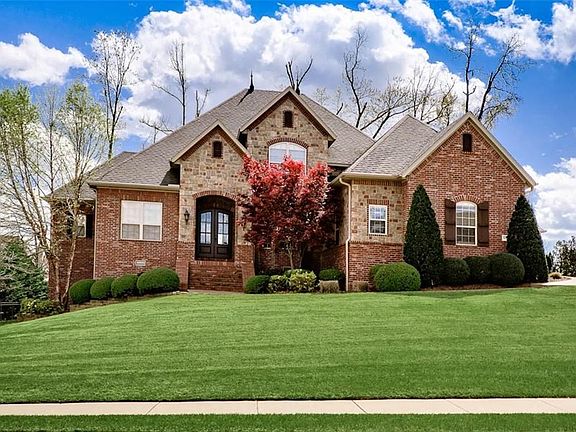 Gorgeous Curb Appeal perched atop a Premium 1/2 Acre Lot in Roger's Premier Golf & Tennis Community 