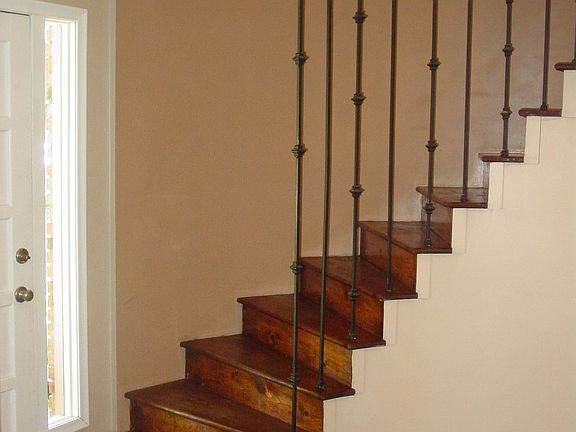 Tiled foyer with curved stairwell.