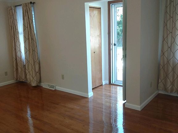 THIS ROOM SHOWS THE HARDWOOD FLOORS AND THE ENTRANCE TO THE FRONT DOOR