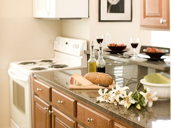 Cherry Cabinetry with Granite Countertops in Kitchens