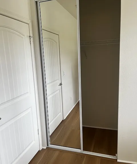 Deep mirrored closet in third bedroom