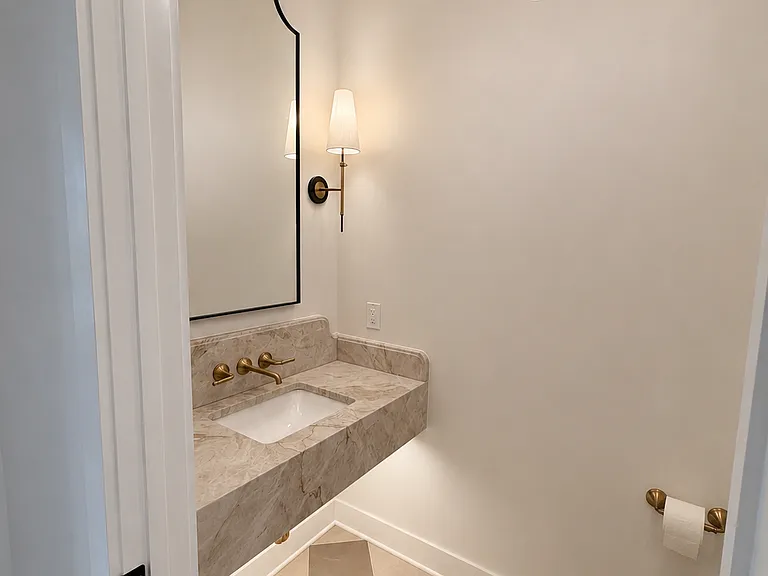Powder Room- First floor powder room with floating Taj Mahal vanity, Edward Martin tile & Rejuvination fixtures & accessories.