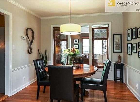 Elegant glass panels dividing dining room and family room.