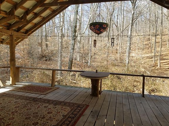 large covered porch overlooking woods