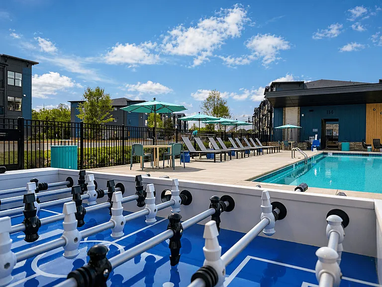 A foosball table set within the pool creates a playful, one-of-a-kind entertainment feature.