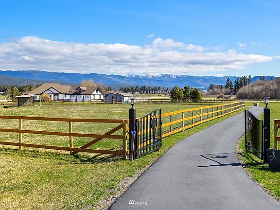 Gated entrance, fenced pastures, and a paved driveway welcome you to this estate.