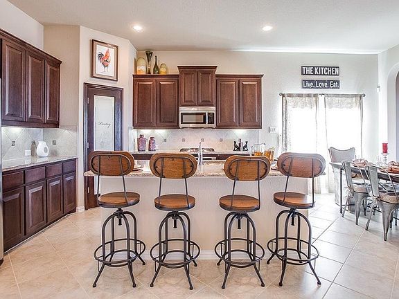 Drawings, pictures, photographs, videos, square footage, floor plans, elevations, features, colors and sizes are for illustration purposes only and will vary from the homes as built. Landscaping and furnishings may be decorator items that are not included in the purchase price and may not be available.