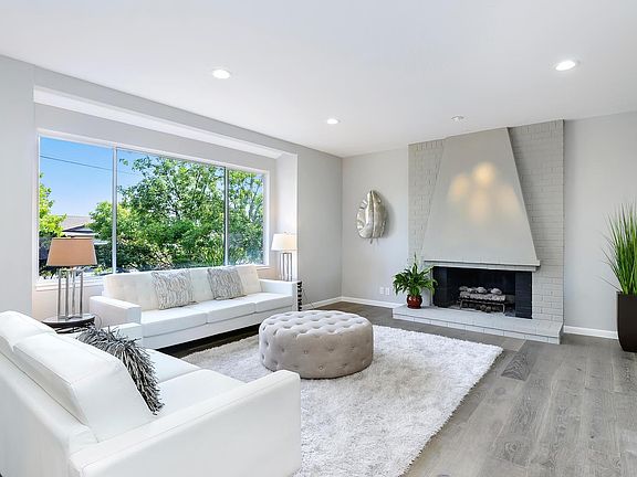 Formal living room with gas fireplace and recessed lights.  