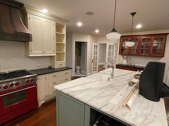Commerical range and hood with granite and marble countertops