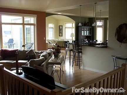 Great Room view northeast to southwest : Open stair to lower lv. Living rm, kitchen, dining rm, sunr