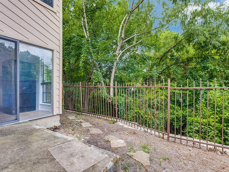 Ground-level patio with sliding glass door entry to interior space