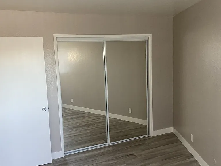 Full sized sliding mirrored door in bedrooms. Great natural light in room. two tone paint with high ceilings.
