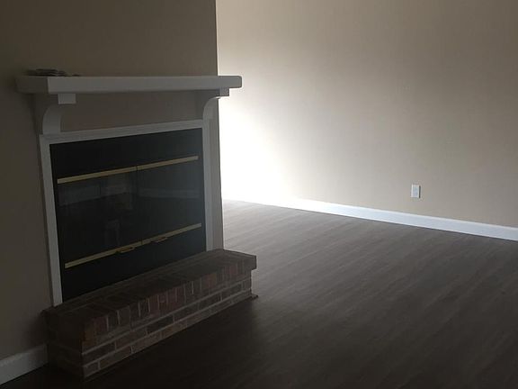 Living room w/wood burning fireplace.