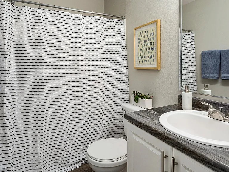 Rediscover daily rituals in generous bathrooms where ample countertops and large mirrors offer a space to redefine your self-care.