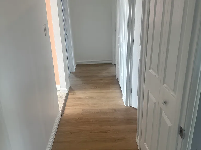 Hallway that connects everything. Living room and bedroom 1 are to the left. Bedroom 2 is to the far right. The bathroom is centered and the master bedroom is behind where the photo was taken. There are two closets in this hallway for extra storage