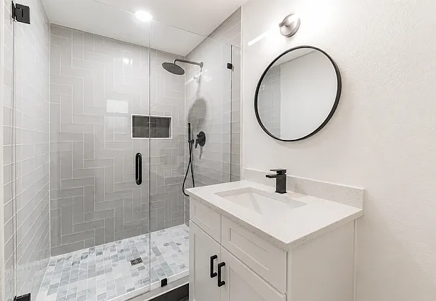 Primary bathroom featuring a spacious walk-in shower with a waterfall showerhead.