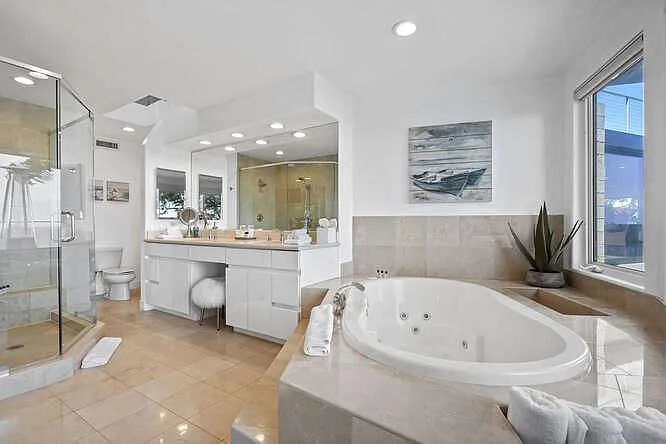 Private ensuite, featuring a spacious jacuzzi bath-tub for a truly rejuvenating experience.