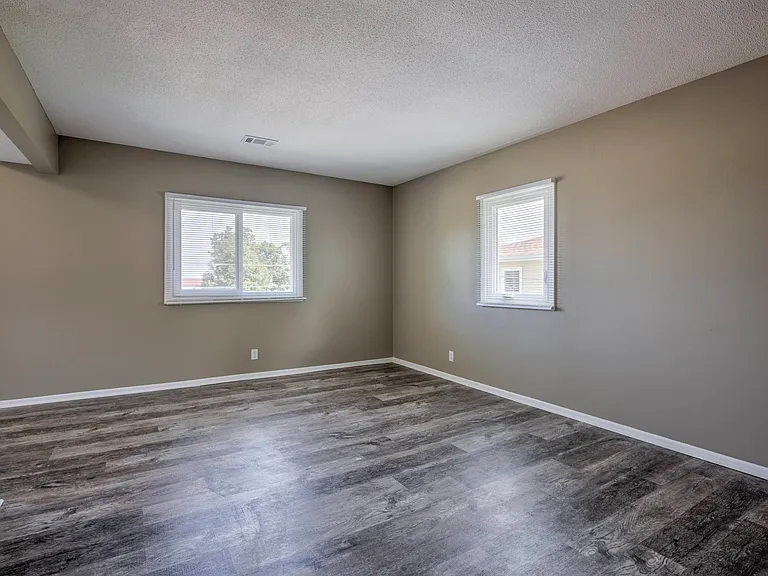 Two windows in living room at Ashland Park Apartments.