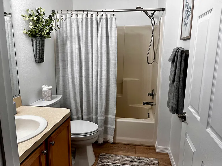 Guest bath with tub and shower combo.