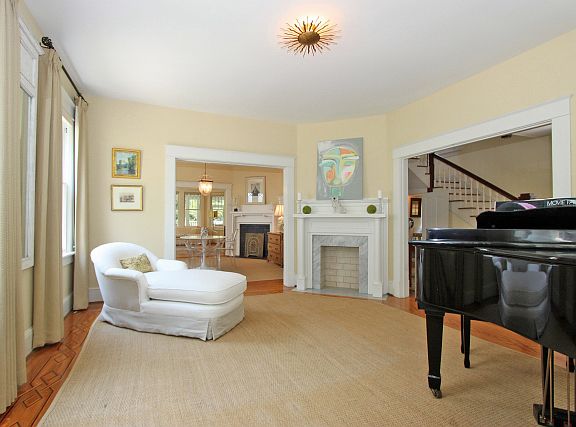 Living room, opening into dining room, into family room. Note corner fireplace.
