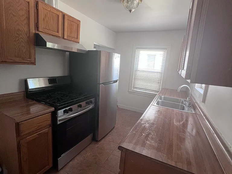 Kitchen with new stove and fridge.