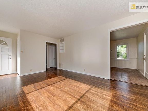 FRONT ROOM LOOKING TOWARD KITCHEN AND HALLWAY