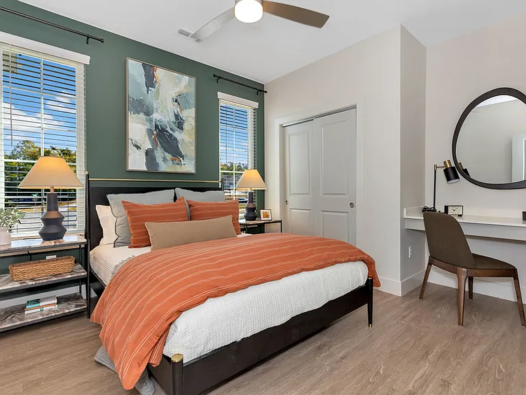 Bedroom with Ceiling Fan, Wood Style Flooring, and Built in Desk