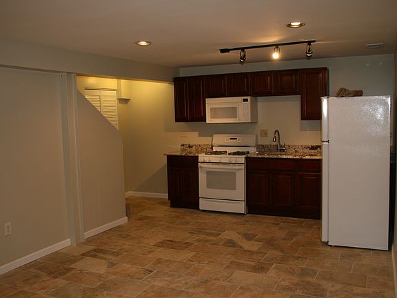View of kitchen and living area. Laundry behind closet door