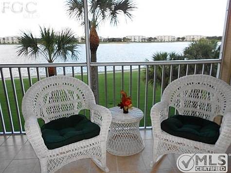 Relax on the tiled screened lanai over looking large central lake.