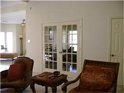 Entry to private den with door to small covered porch.