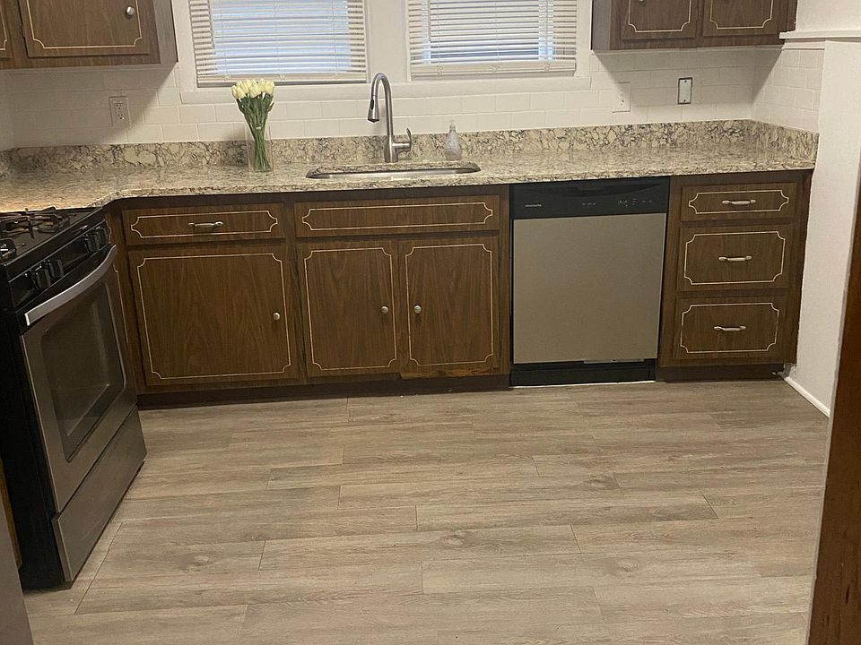 bright spacious kitchen with quartz counters and stainless steel appliances