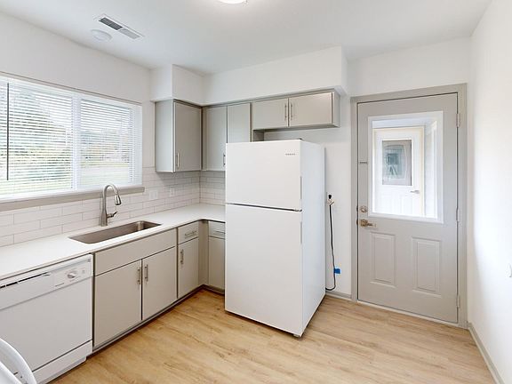 Kitchen and back patio door that leads to garage